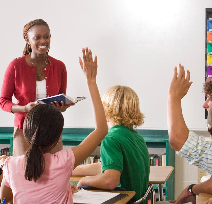 Students raising their hands in class